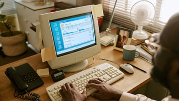 Man looking at old computer reading about AWS Savings Plans